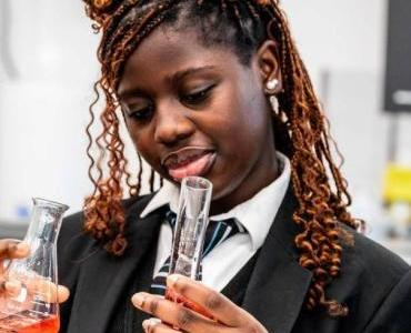 Smiling students wearing headphones